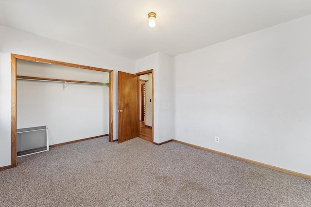 unfurnished bedroom featuring carpet and a closet