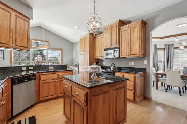 N33W29204 Millridge Rd, Pewaukee, WI 53072 - kitchen featuring dark stone countertops, vaulted ceiling, pendant lighting, a kitchen island, and stainless steel appliances