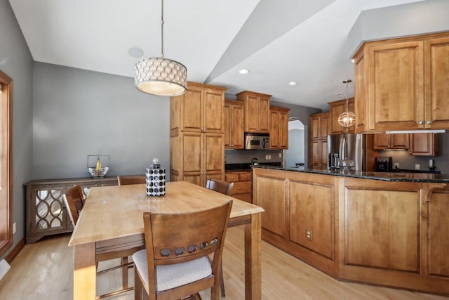 N33W29204 Millridge Rd, Pewaukee, WI 53072 - kitchen with light hardwood / wood-style flooring, dark stone countertops, pendant lighting, and appliances with stainless steel finishes