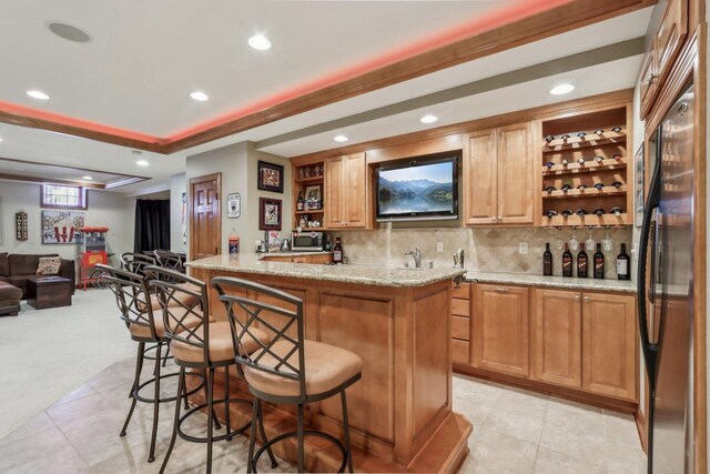 N33W29204 Millridge Rd, Pewaukee, WI 53072 - bar with appliances with stainless steel finishes, light tile patterned flooring, light stone counters, and backsplash