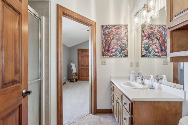 N33W29204 Millridge Rd, Pewaukee, WI 53072 - bathroom featuring vanity, vaulted ceiling, tile patterned flooring, and walk in shower