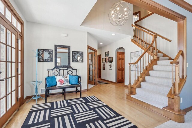 N33W29204 Millridge Rd, Pewaukee, WI 53072 - foyer entrance featuring french doors, a chandelier, and light hardwood / wood-style flooring