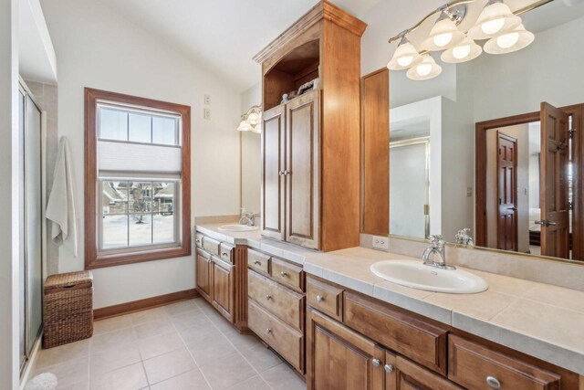 N33W29204 Millridge Rd, Pewaukee, WI 53072 - bathroom featuring vanity, vaulted ceiling, an enclosed shower, and tile patterned floors