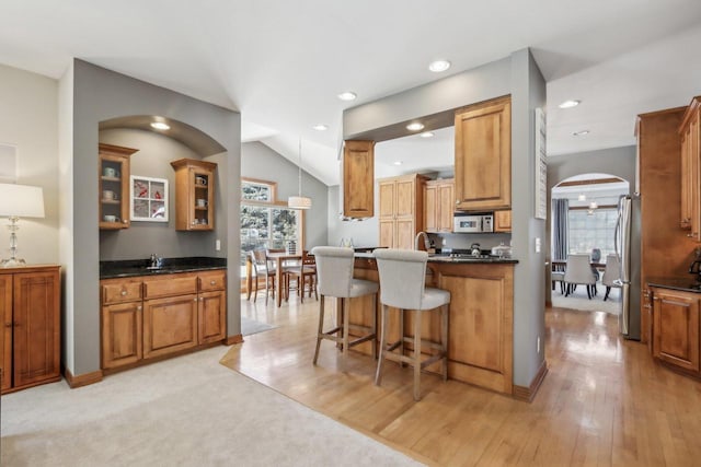 N33W29204 Millridge Rd, Pewaukee, WI 53072 - kitchen with vaulted ceiling, sink, decorative light fixtures, stainless steel appliances, and a breakfast bar area