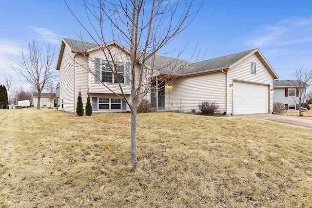 split level home featuring a garage, driveway, and a front lawn