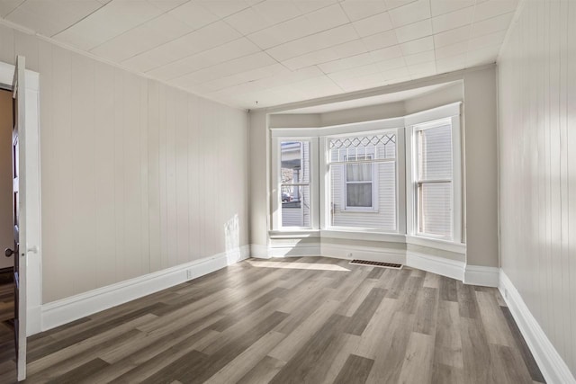 unfurnished room with hardwood / wood-style floors