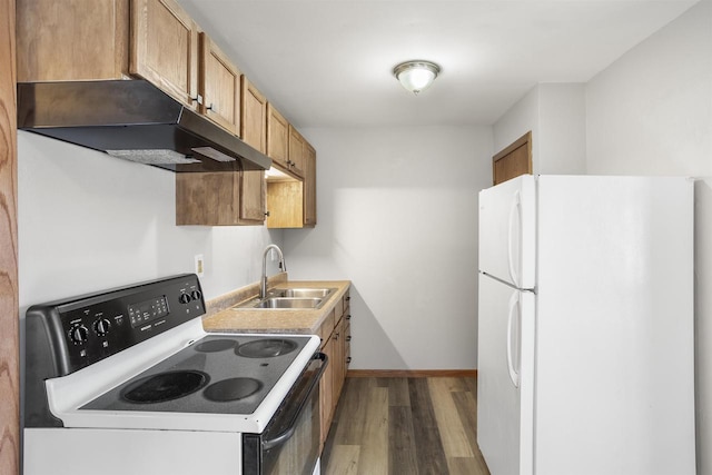 kitchen featuring white refrigerator, range with electric cooktop, sink, and hardwood / wood-style floors