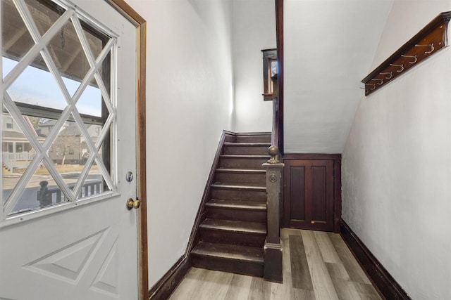 stairs featuring hardwood / wood-style floors