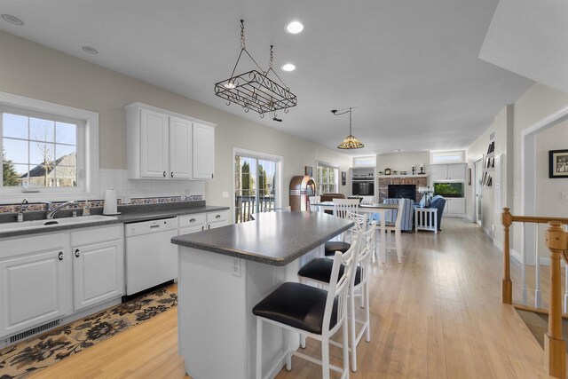 1809 Shady Point Dr, Verona, WI 53593 - kitchen featuring pendant lighting, sink, a breakfast bar area, dishwasher, and white cabinets