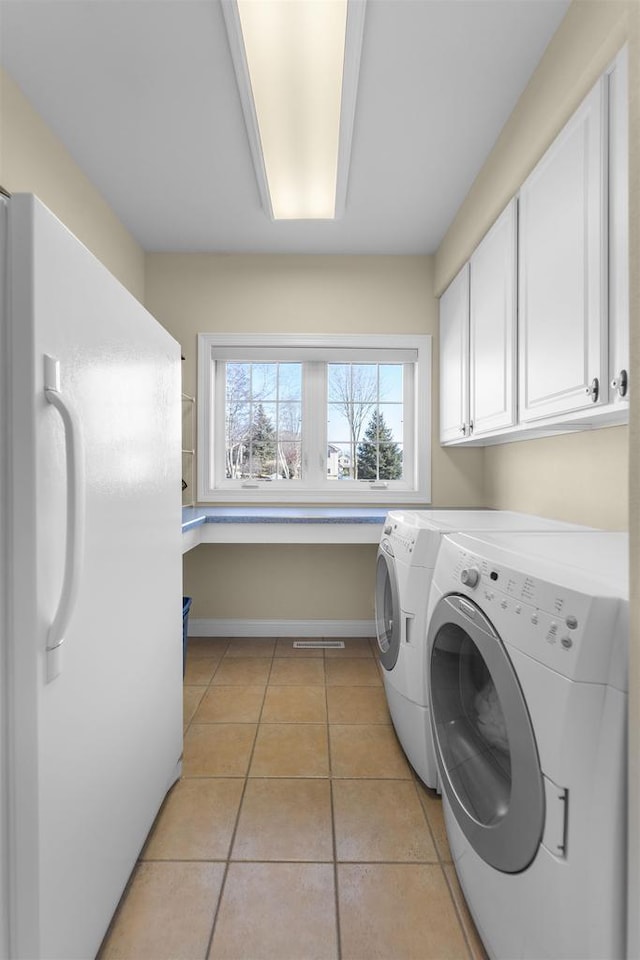 1809 Shady Point Dr, Verona, WI 53593 - laundry area featuring cabinets, washer and dryer, and light tile patterned floors