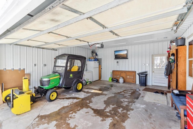 garage featuring a garage door opener and white refrigerator