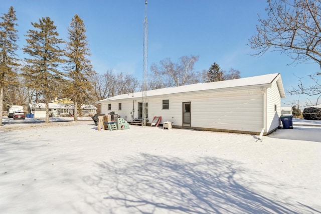 view of snow covered back of property