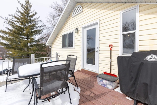 wooden deck with a grill