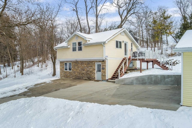 view of snow covered exterior featuring a deck