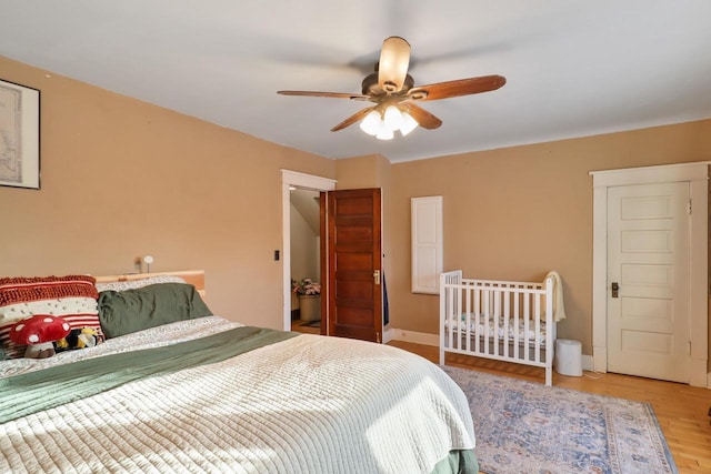 bedroom with light hardwood / wood-style floors and ceiling fan