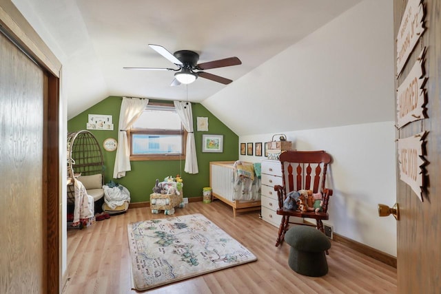 sitting room with ceiling fan, lofted ceiling, and light hardwood / wood-style floors