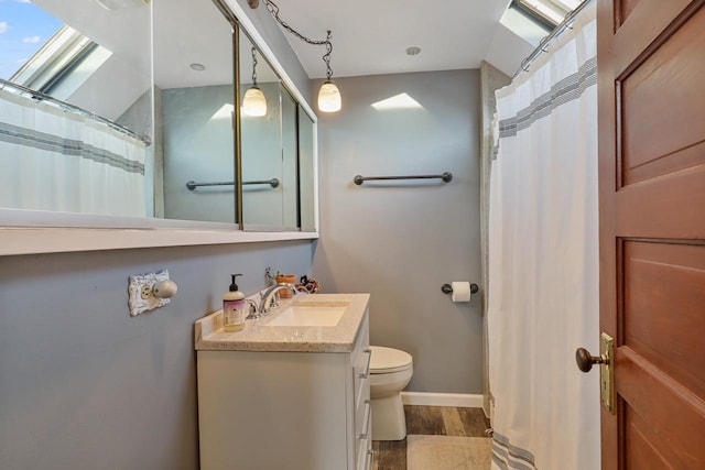 bathroom with wood-type flooring, toilet, and vanity