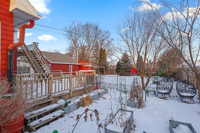 yard layered in snow with a wooden deck