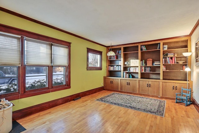 office featuring ornamental molding and light hardwood / wood-style floors