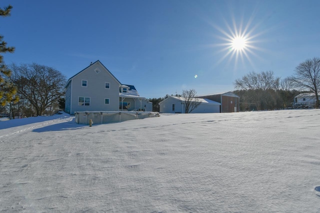 yard covered in snow featuring a storage shed