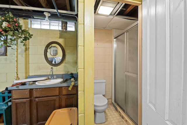 bathroom featuring walk in shower, vanity, and toilet