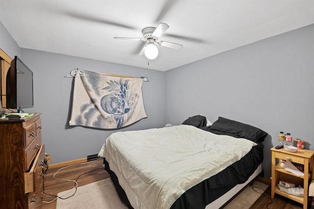 bedroom with hardwood / wood-style flooring and ceiling fan