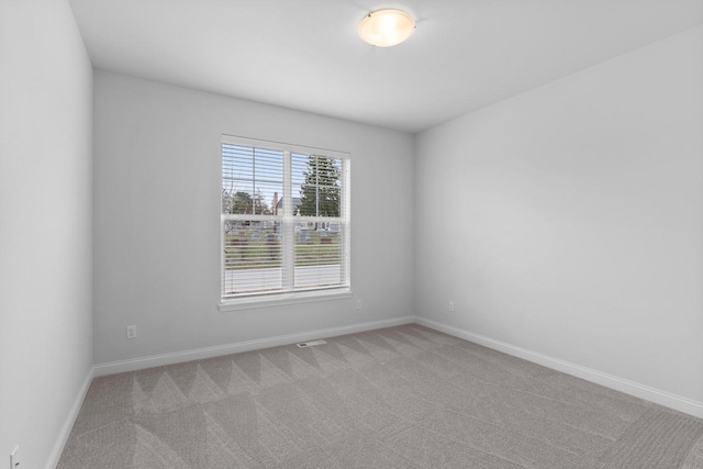 empty room featuring light colored carpet