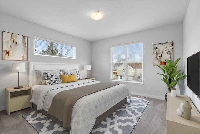 carpeted bedroom featuring multiple windows