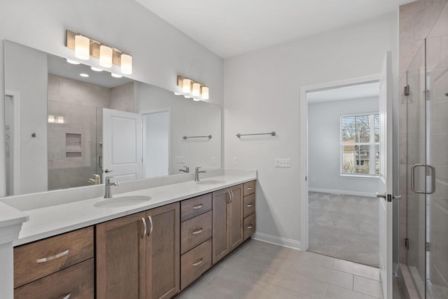 bathroom with vanity, a shower with shower door, and tile patterned flooring