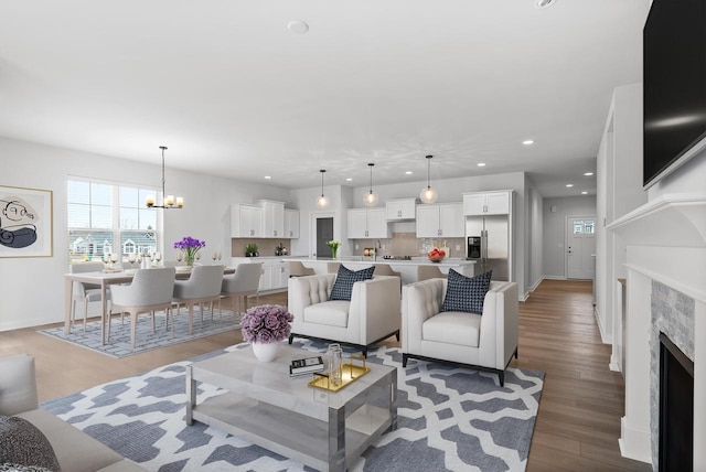 living room with a notable chandelier and wood-type flooring