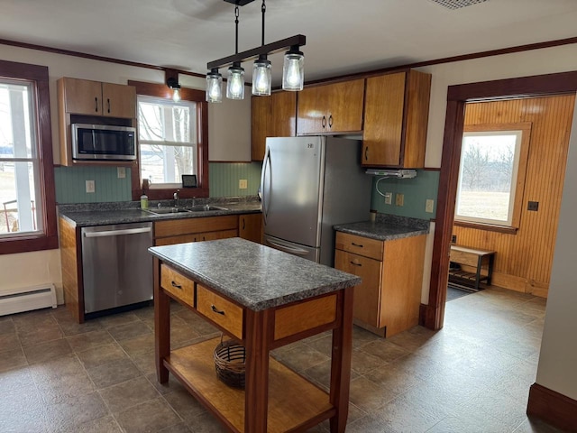 kitchen with sink, decorative light fixtures, a baseboard radiator, appliances with stainless steel finishes, and decorative backsplash