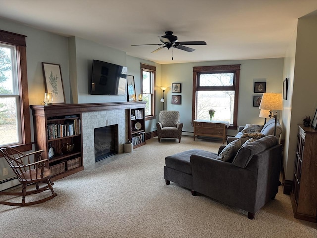 living room with ceiling fan, light colored carpet, and a healthy amount of sunlight