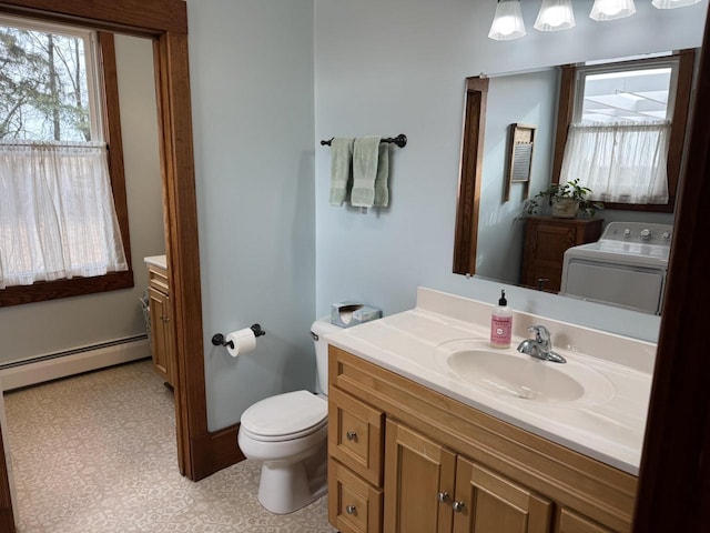 bathroom featuring toilet, a baseboard radiator, vanity, and washer / clothes dryer