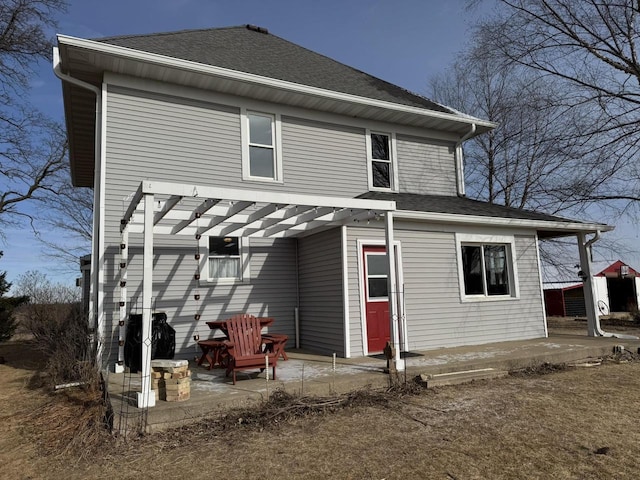 back of property featuring a pergola and a patio area