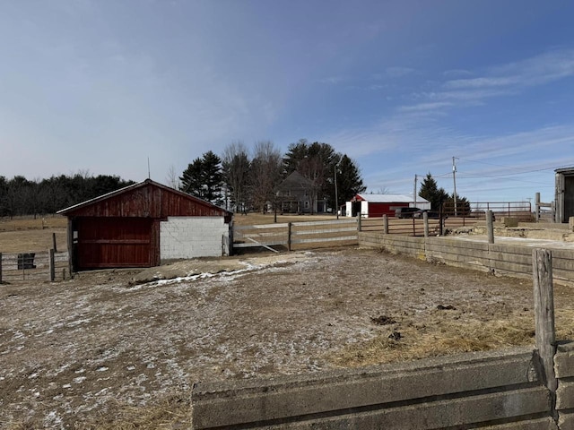 view of yard with an outbuilding and a rural view