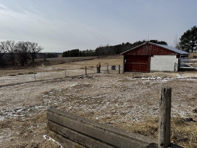 view of yard with an outbuilding and a rural view