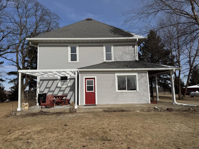 rear view of property featuring a yard and a patio