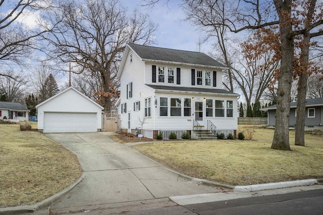 view of front facade with a garage, an outdoor structure, and a front lawn