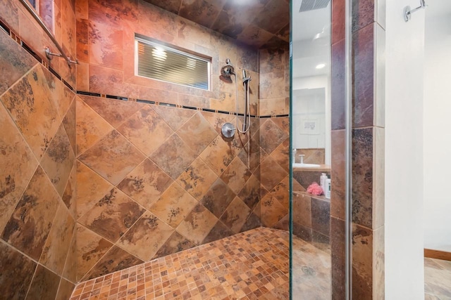 bathroom with tiled shower