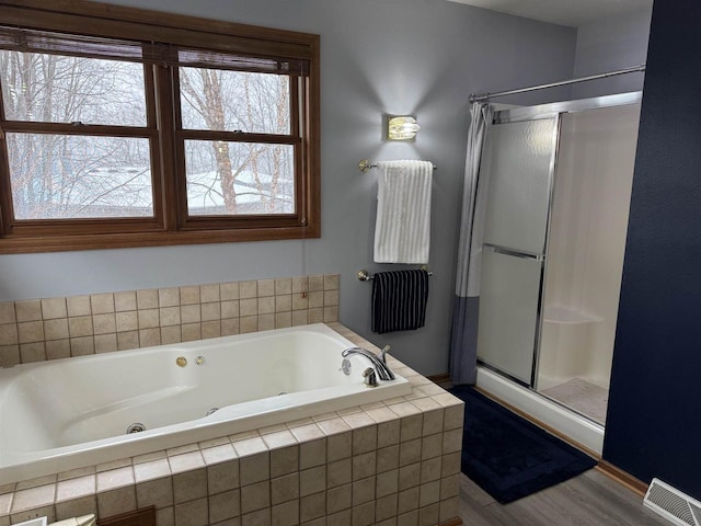 full bathroom with a stall shower, visible vents, and a jetted tub