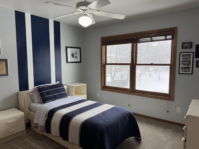 bedroom featuring dark colored carpet, ceiling fan, and baseboards