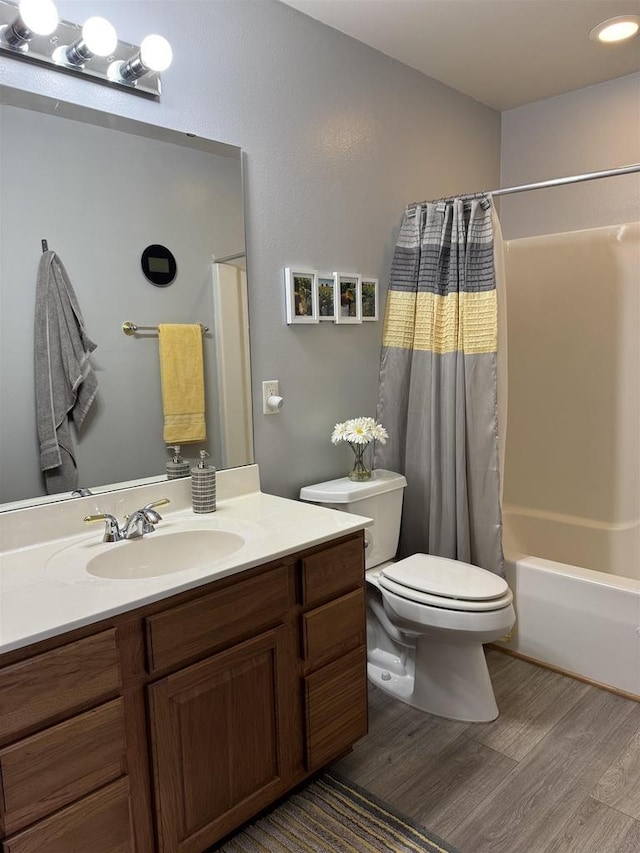 full bathroom with shower / bath combo with shower curtain, vanity, toilet, and wood finished floors