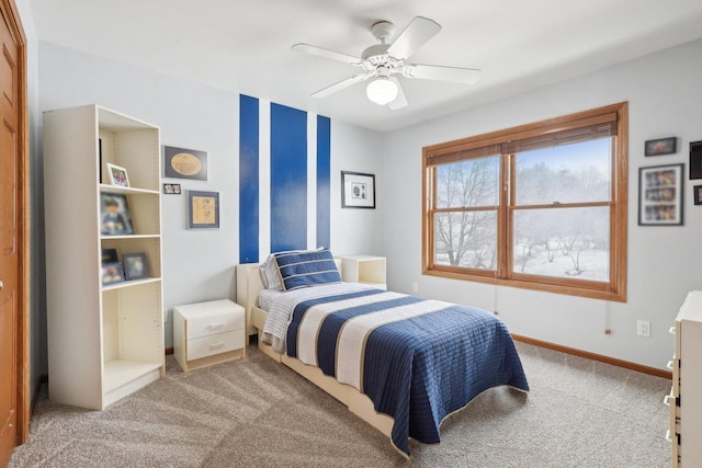 carpeted bedroom featuring a ceiling fan and baseboards