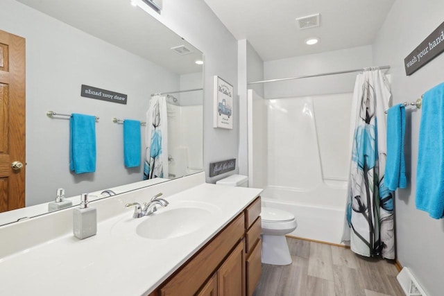 bathroom featuring toilet, wood finished floors, and visible vents