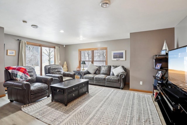 living room with light wood finished floors and baseboards