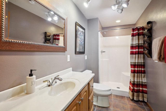 full bath featuring toilet, a stall shower, tile patterned floors, and vanity