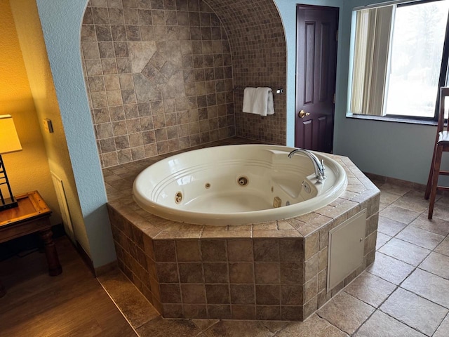 bathroom with tiled tub