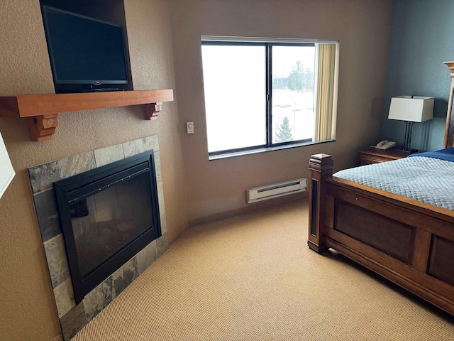 bedroom with a tile fireplace, a baseboard radiator, and light carpet