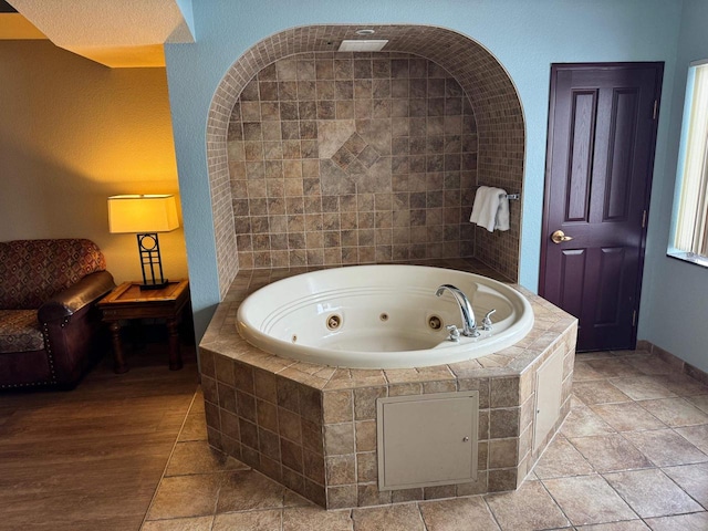 bathroom featuring a relaxing tiled tub