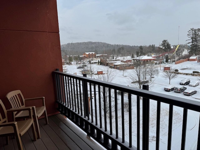 view of snow covered back of property